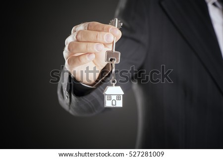 Real estate agent handing over house keys 