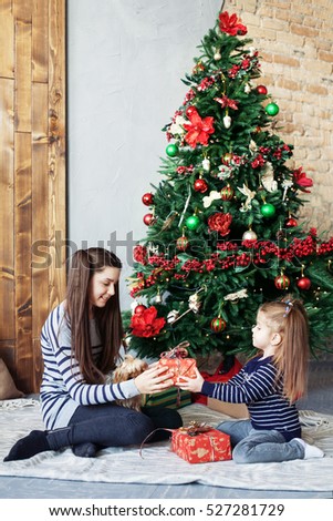 Children open presents on Christmas. The concept of Christmas and New Year.