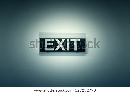 Exit sign on white wall, symbol