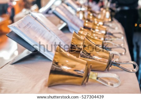 Handbells with sheet of music ready for performance Royalty-Free Stock Photo #527304439