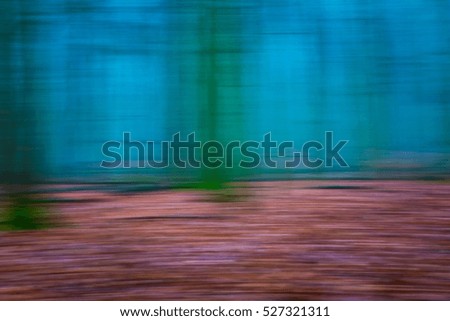 Forest abstract blurred background. Autumn, nature backdrop concept with trees trunks blurred.