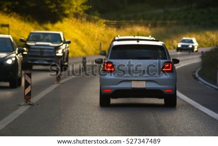 Cars on busy road driving in evening Royalty-Free Stock Photo #527347489