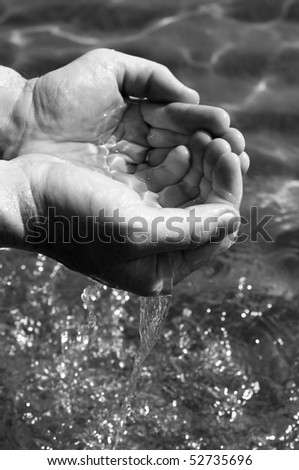 man hands catching water from the sea