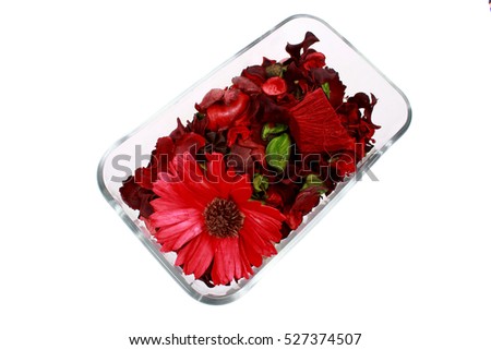 Dried red flowers in a glass vase on a white background