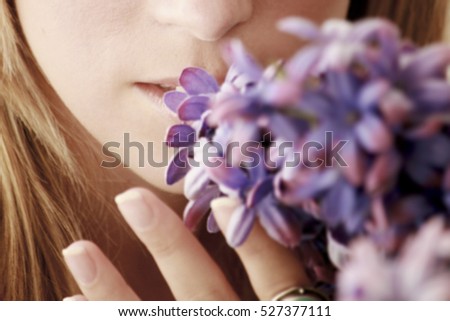 close a part of a girl smelling flowers Royalty-Free Stock Photo #527377111