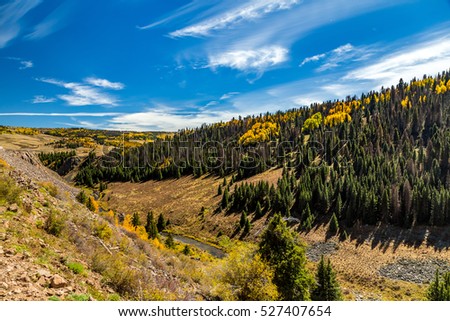 Beautiful mountain scenery with streams, valleys, and color changing trees along a train route from Chama, New Mexico to Antonito, Colorado