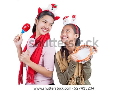 Happy and cheerful christmas carolers with percussion instruments. Isolated in white background.