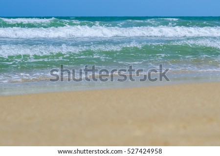 Waves in the ocean and sand on the beach in Thailand