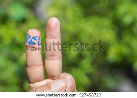 bandaid on hand crying with blur background