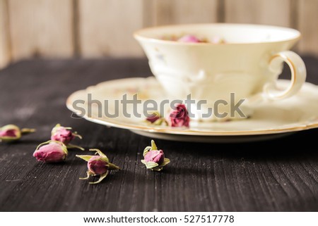 Vintage cup of tea with buds of roses, fragrant breakfast aristocracy