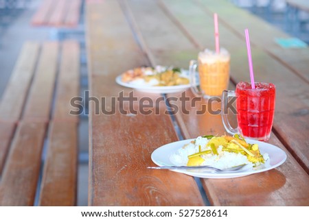 thai food on wood table in thai cafeteria . selective focus and blur background.