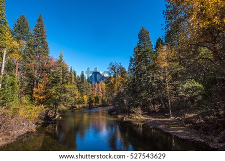 Fall Autumn reflections in the Merced River in Yosemite National Park California - see half dome and the fall colors