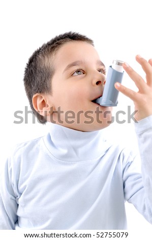 Close up image of a cute little boy using inhaler for asthma. White background MEDICAL related studio picture
