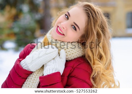 a girl dresses up a fir-tree in the winter forest much snow in expectant of New Year gladness of toy on a fir-tree beauty holiday blonde winter