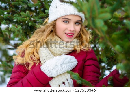 a girl dresses up a fir-tree in the winter forest much snow in expectant of New Year gladness of toy on a fir-tree beauty holiday blonde winter