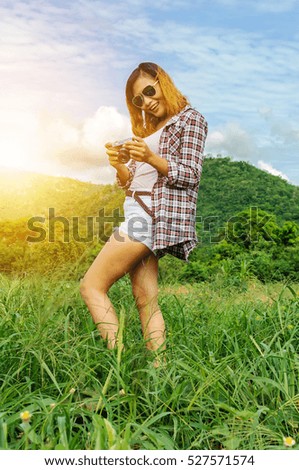 Pretty woman take a photo with classic camera,Hipster girl take photos in nature ,landscape,macro picture .She is traveler, vintage tone
