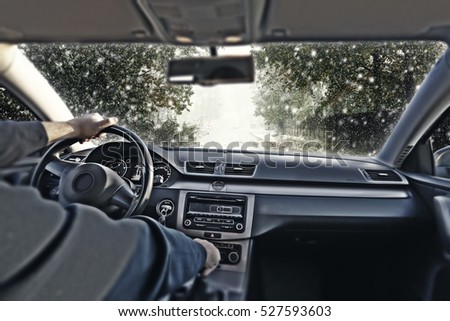 car interior and winter road with snow 