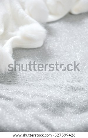 Glitter grey background with white puffy scarf