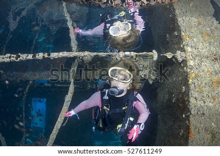Diver with Reflection inside the SS Thistlegorm shipwreck near Ras Muhammed, Red Sea, Egypt. Royalty-Free Stock Photo #527611249