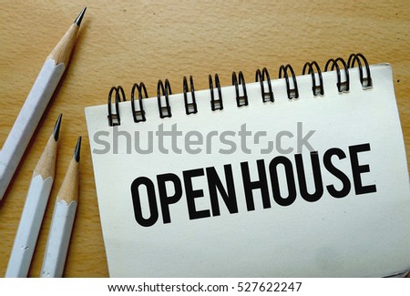 Open House text written on a notebook with pencils
