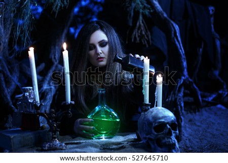 On eve of Halloween witch casts a spell, uttering a terrible curse on bottles of potion.Fabulous, spooky voodoo shack.Magic Shine.Fabulous and mystical concept.Fashionable toning.Creative color.