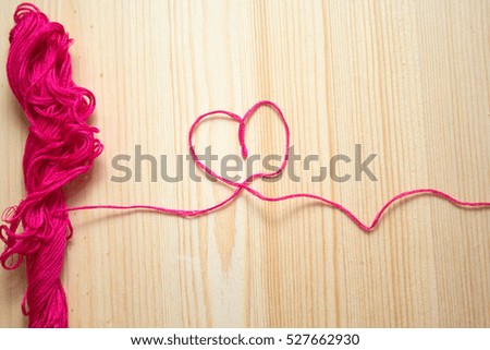 embroidery floss on wooden background. handmade concept