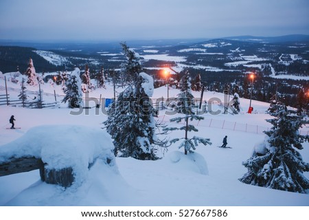 Beautiful cold mountain view of ski resort, winter day with slope, piste and ski lift, evening twilight night picture