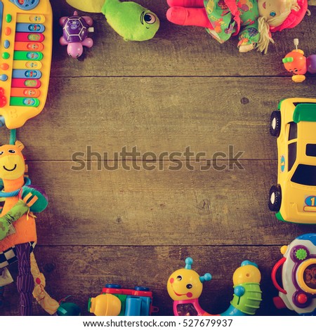 Frame made of toy accessories for children on wooden background. Top view. copy space.