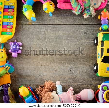 Frame made of toy accessories for children on wooden background. Top view. copy space.