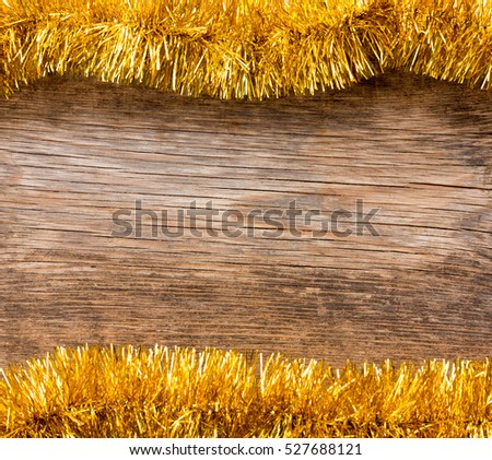 New Year, Christmas background with space for text. Old wooden boards framed by golden tinsel