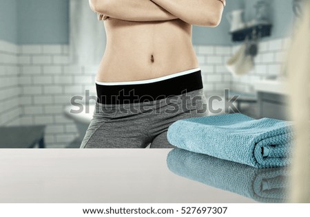 free space on shelf with towel and slim woman body in bathroom 