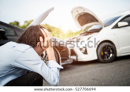Asia man driver man in front of automobile crash car collision accident in city road. Royalty-Free Stock Photo #527706694