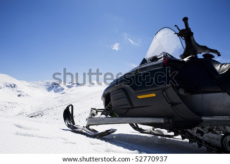 Motor sledge on a snow mountain
