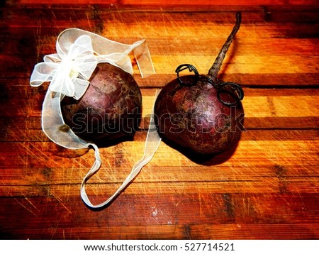 on a wooden chopping board Two purple vegetable beet boy with glasses and a girl with a big bow beets express feelings