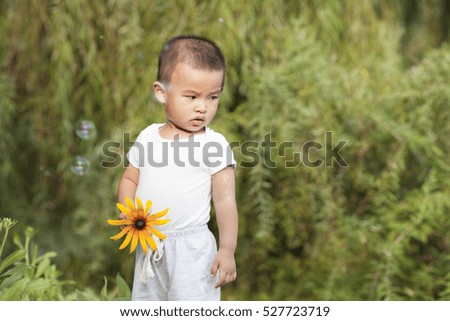 Cute Chinese baby boy playing in a park, shot in Beijing, China