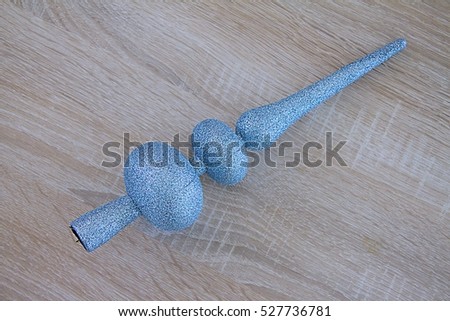 Blue Silver Christmas decoration for hanging on top of the Christmas or Pine tree, on wooden background
