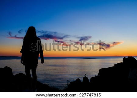 Sunset over the ocean,  Silhouette of rocks Royalty-Free Stock Photo #527747815