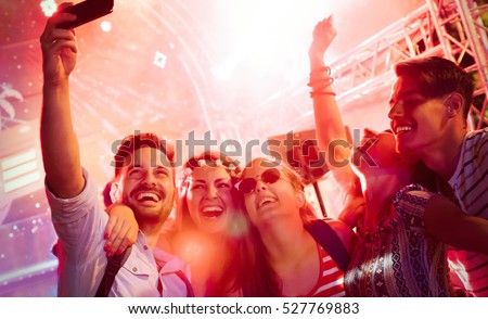 Cheerful friends partying in club at night Royalty-Free Stock Photo #527769883