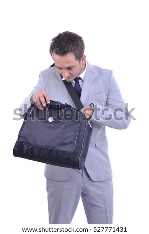 Young businessman looking for something in his business bag