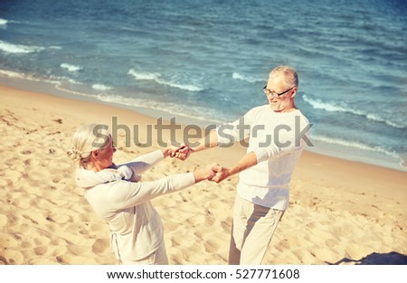 family, age, travel, tourism and people concept - happy senior couple holding hands on summer beach