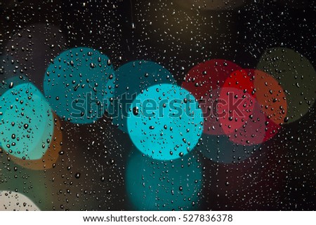 rainy days rain drops on the window with traffic bokeh light 