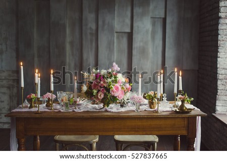 Wedding decoration. Candles on the table with decor and a bouquet of pink and white flowers . 