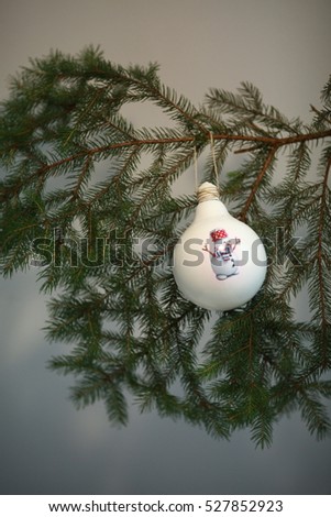 New Year and Christmas theme. Hand made Christmas balls on Xmas Tree. Christmas ball with picture of Santa.