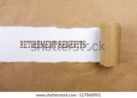 Torn brown paper on white surface with "RETIREMENT BENEFITS" word. Business concept