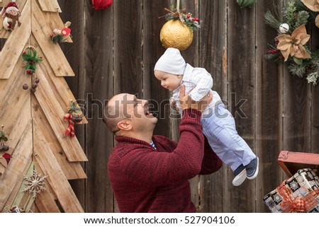 Father and little baby boy spend time together. Christmas background.