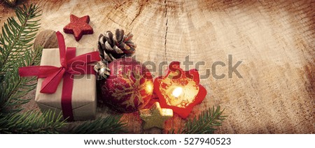 Christmas gift with red ball ,candle and fir branch , top view with copy space on wood. Christmas card.