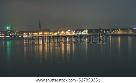 city light reflections over water at the night. Riga, Latvia - vintage look