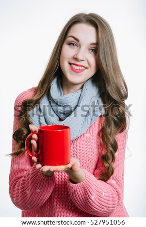 Young woman holding a red cup isolated on the white background