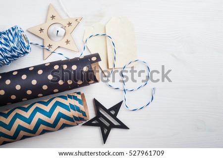 Christmas present wrapping paper and twine, wooden vintage toys, tags. Modern lifestyle composition in scandinavian style
