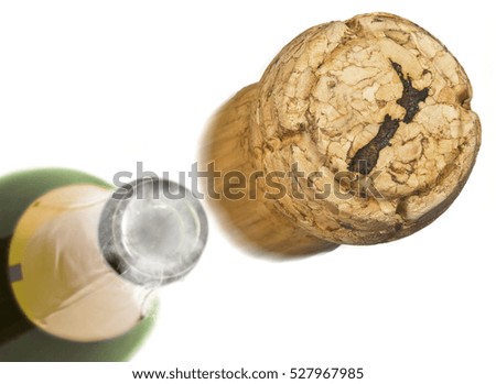 Champagne cork with the shape of New Zealand burnt in and bottle of champagne in the back.(series)